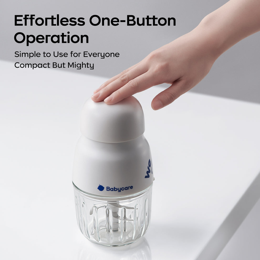 This image features a food processor. A hand presses the top button, showcasing “Effortless One - Button Operation”. The text “Simple to Use for Everyone Compact But Mighty” highlights ease of use and functionality.
