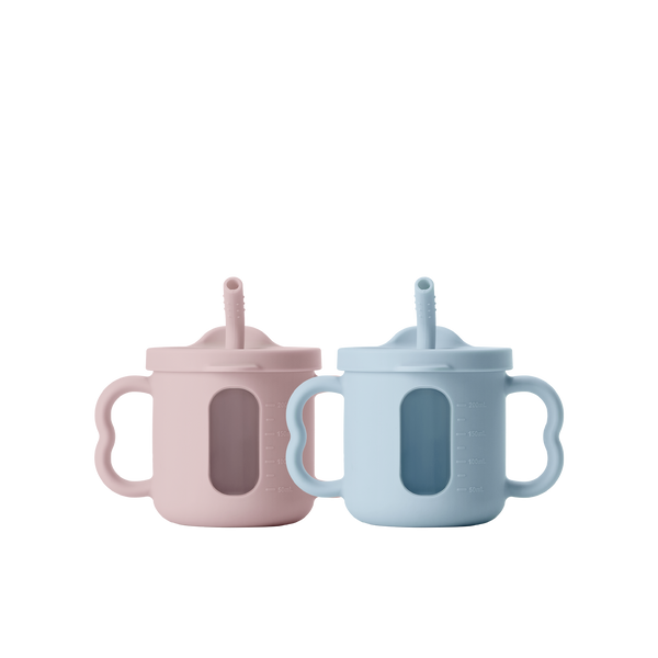 Two seesip silicone cups with handle  on a white background, one blue and one pink