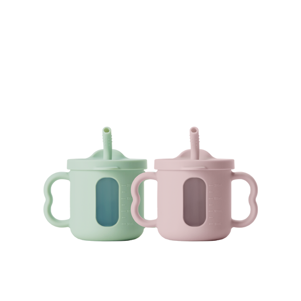 Two seesip silicone cups with handle  on a white background, one blue and one pink
