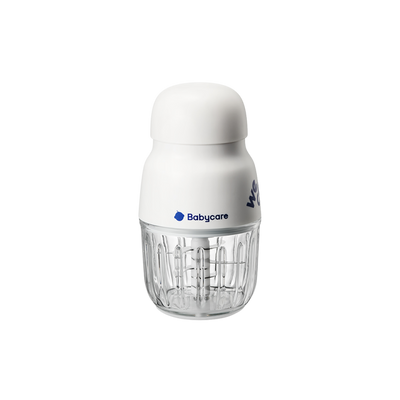 This image shows a Bc Babycare food processor. It has a white top section and a transparent base. The compact design is visible, along with the “Bc Babycare” logo on the front. The product stands on a light - colored surface, with a simple background.
