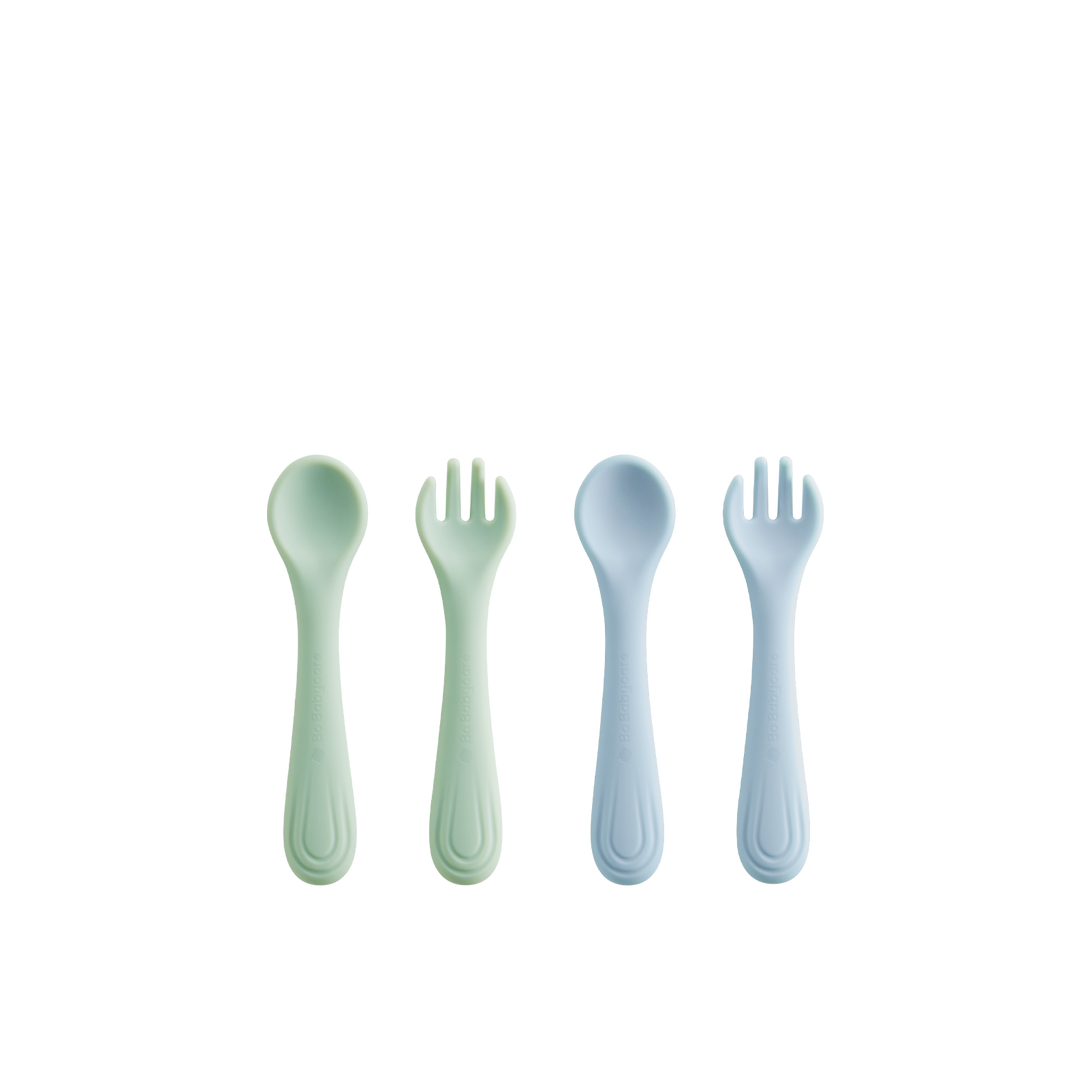 Two silicone fork and spoon sets, one blue and one green, arranged on a white background (four pieces total).
