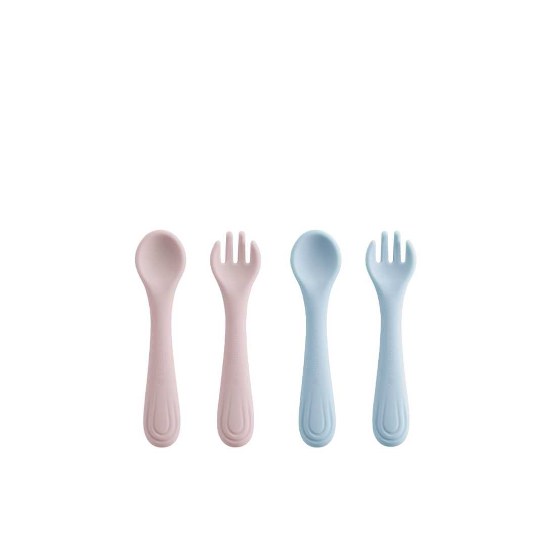Two silicone fork and spoon sets, one blue and one pink, arranged on a white background (four pieces total).