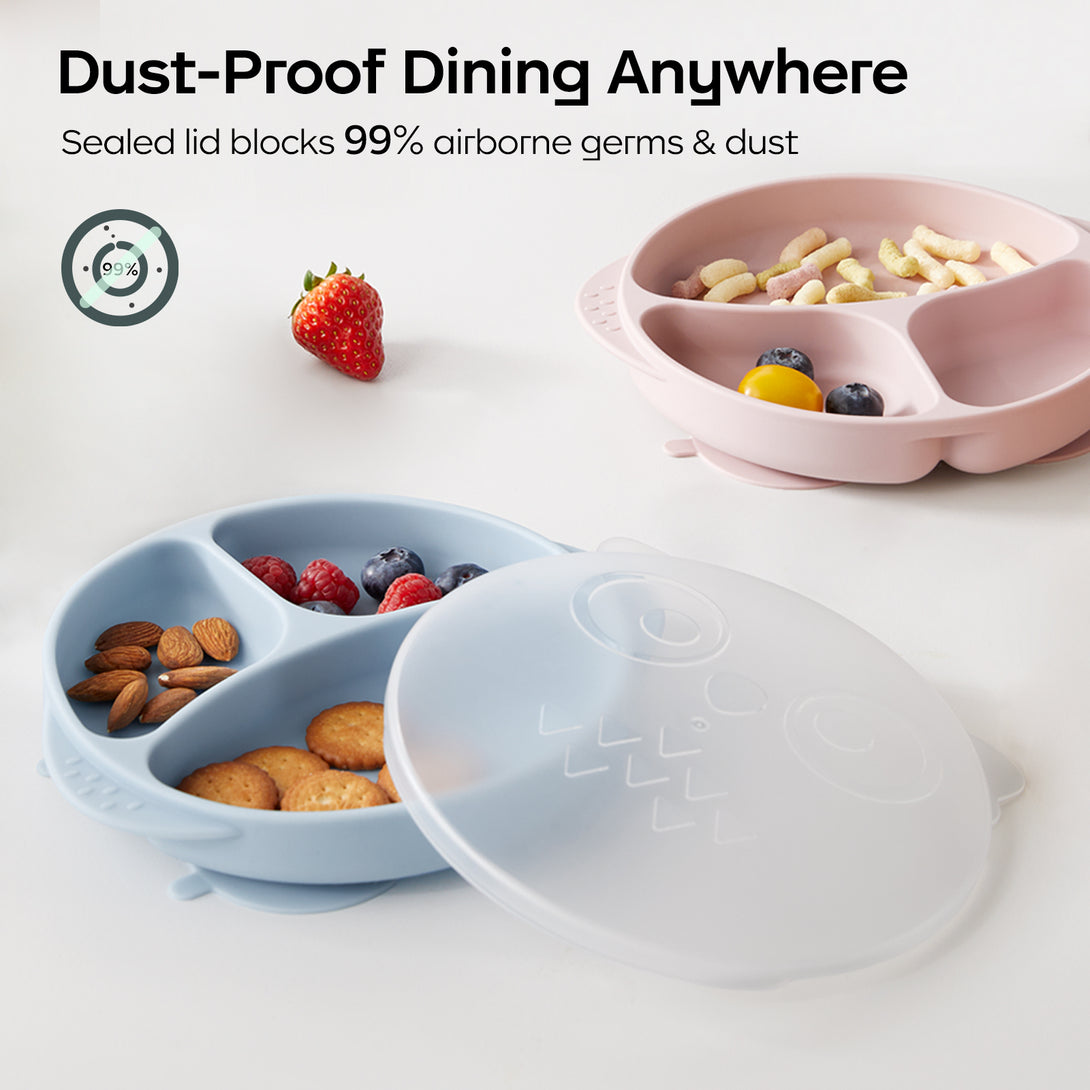Two silicone suction plates with snacks on a table. Sealed lid beside plates. Text overlay: 'Dust-Proof Dining Anywhere' and 'Blocks 99% Airborne Germs & Dust.