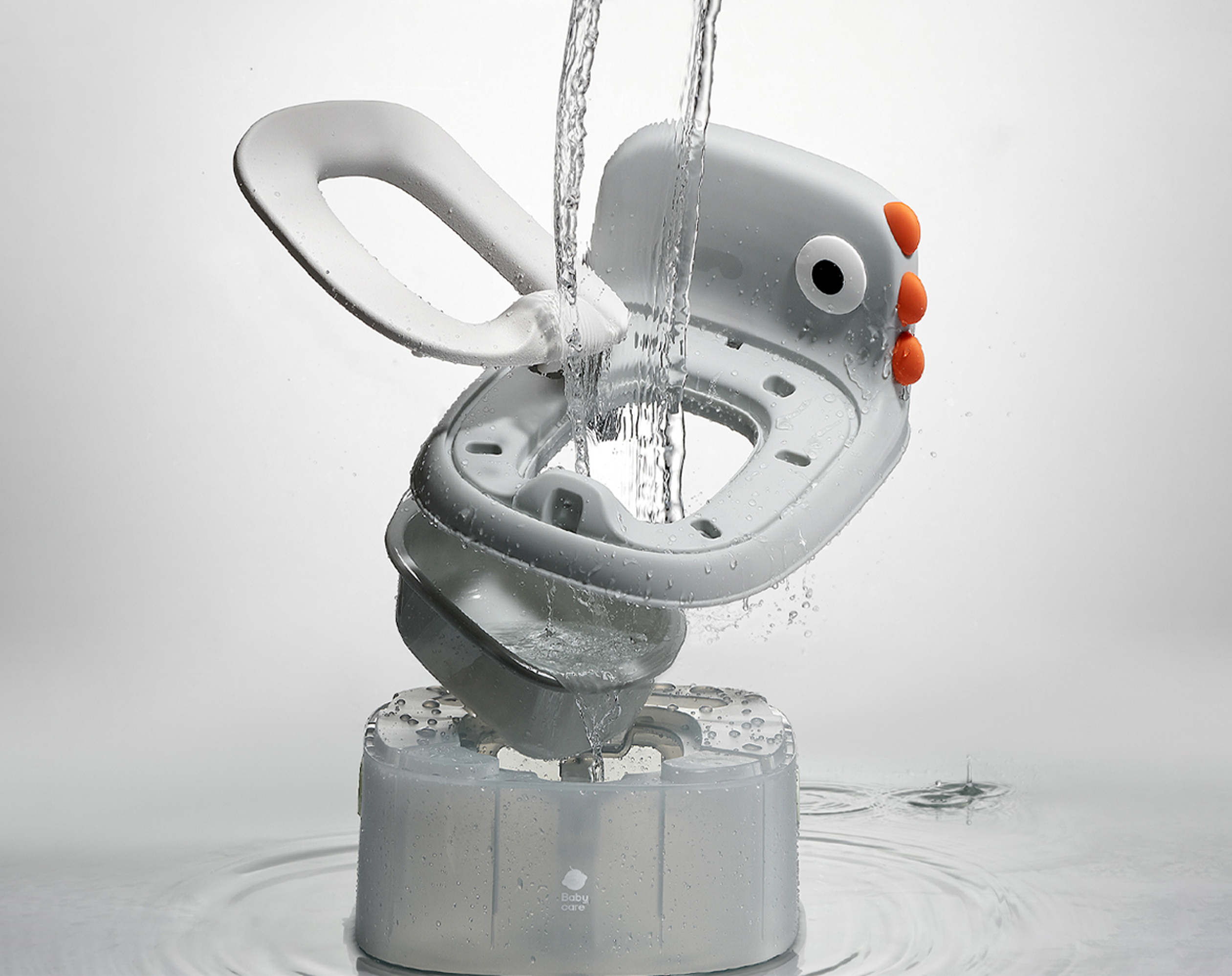 Detachable parts of the Bc Babycare Potty Chair shown under running water for easier cleaning.
