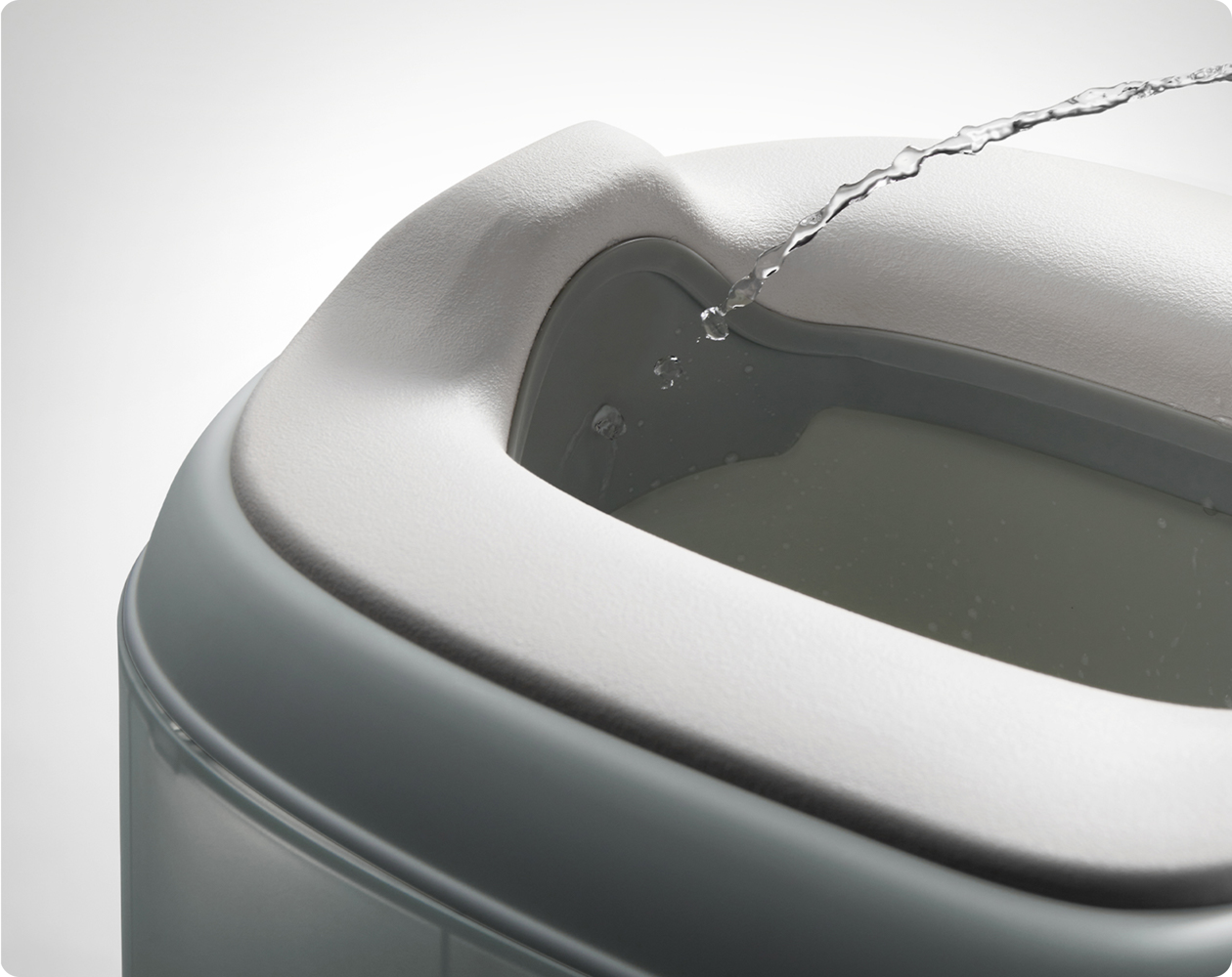 Close-up of the curved raised splash guard on the Bc Babycare Potty Chair.