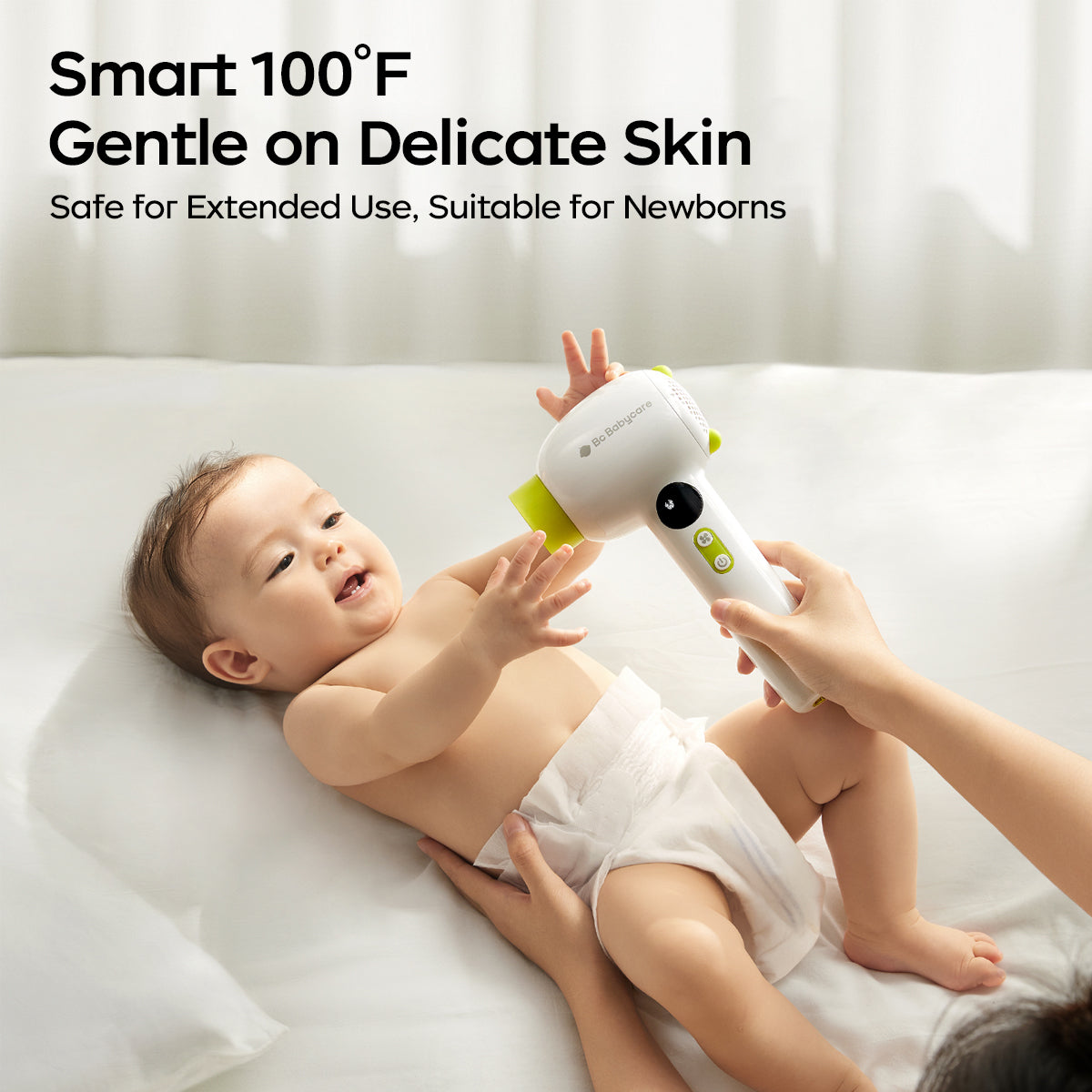 A hair dryer is blowing a newborn baby. 