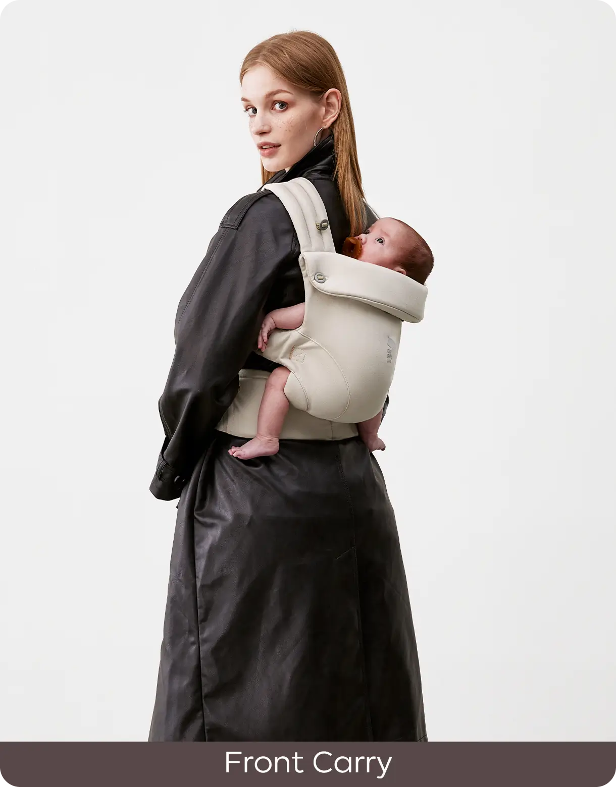 Parent carrying a baby in the CocoonGo Baby Carrier using the front carry position.