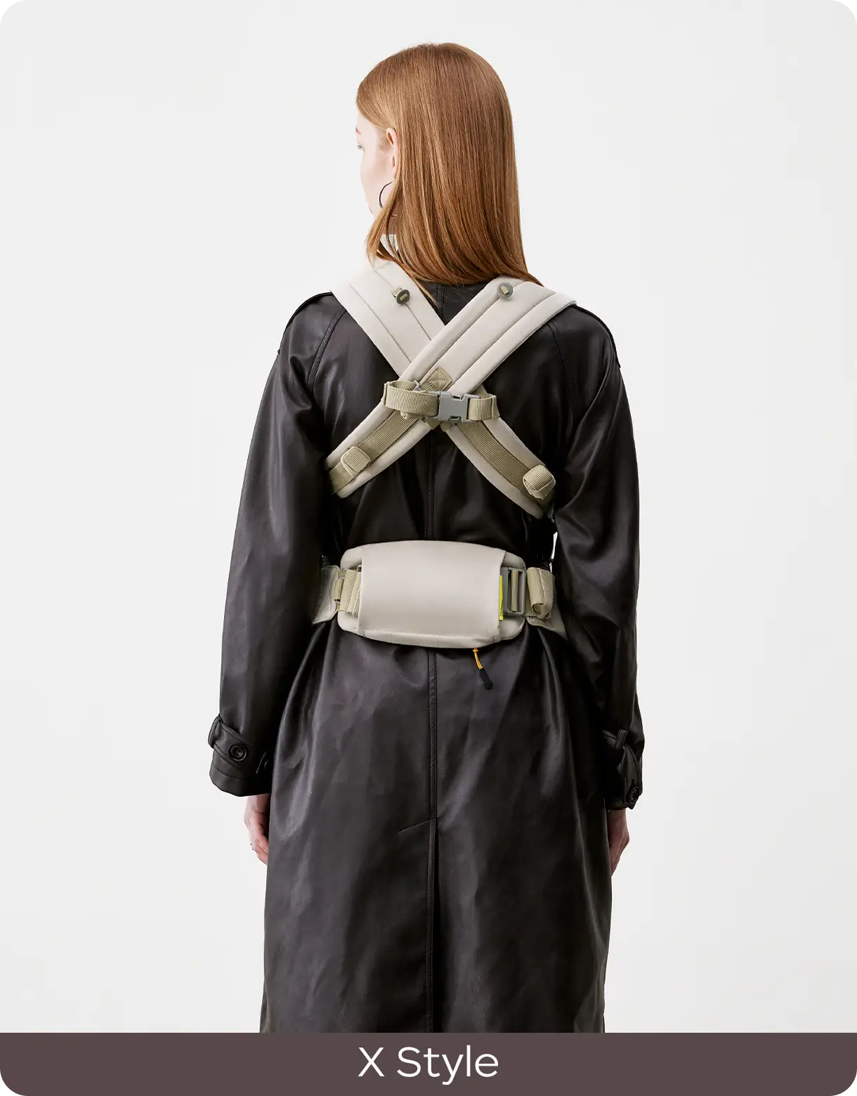 Rear view of the CocoonGo Baby Carrier worn with crossed X-style shoulder straps.